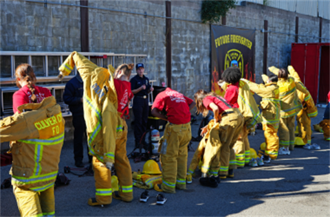 Girls Camp Attendees Don Firefighter Gear